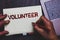 Word writing text Volunteer. Business concept for Volunteering individual for greater social cause serving others Notepad marker p