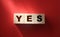 Word Yes on wooden blocks. Business, motivation and education concept