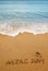 Words Anzac day and Australian flag on the sand of seashore.Lest we forget