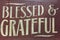 Words blessed and grateful print on red wood wall