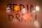 The words brain drain written on night wet window glass close-up with blurred background in orange colors