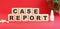 The words CASE REPORT is made of wooden cubes on a red background. Medical concept.