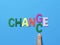 Words chance and change made from colorful alphabets with against blue background.