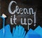 The words `clean it up!`on the chalkboard above the spring cleaning kit.