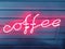 Words of coffee from a neon tube pink glow