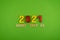 The words dream, plan, go 2021 is lined with wooden letters on a green background. Figures from the constructor top view