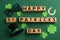 Words Happy St. Patrick`s day and festive decor on green background, flat lay