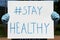 The words `hashtag stay healthy` written on a sign.