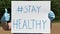 The words `hashtag stay healthy` written on a sign.
