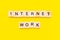 Words internet work. Wooden blocks with lettering on top of yellow background. Human Resource Management and Recruitment