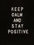 The words Keep Calm And Stay Positive on black felt letter board