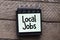 The words Local Jobs written by hand on a sticky note