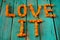 Words Love It written by fresh bright orange pumpkin cubes on wo