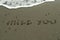 Words Miss You on beach sand