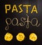 Words pasta made of cooked spaghetti and dry pasta on the black background with frame of country Italy written by chalk