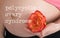 Words POLYCYSTIC OVARY SYNDROME. Young pregnant woman keeps natural rose blossom close to her belly