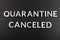 The words quarantine canceled laid with silver metal letters on matte back flat surface directly above in flat lay