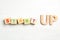 Words START UP made with wooden blocks on white background, flat lay