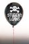 The words student loans in white and a skull and cross bones on a balloon illustrating the concept of a debt bubble