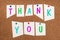 The words thank you are pinned to a pin up wall, colorful cut out letters, being thankful, communication concept