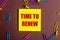 The words TIME TO RENEW is written in red on a yellow sticker on a brown background next to multi-colored paper clips