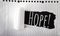 Words, writing hope. Photo concept for Inspiration and Motivation written on black paper on the white folded paper.