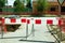 Work ahead street reconstruction site with sign and fence as road barricade