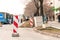 Work ahead street reconstruction site with sign and fence as road barricade