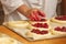 Work in bakery, making fruit filled pies