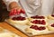 Work in bakery, making fruit filled pies