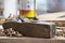 A work bench with wood shaver tool used in carpentry. Wood work done over a bench