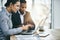 They work best when they work together. two businesspeople working together on a laptop in an office.