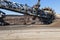 work of a bucket wheel excavator in a quarry. Ore mining in a quarry