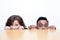 Work colleagues peeking over edge of table