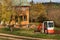 Work on the construction site of an ecological house. The excavator adjusts the terrain. A small digger in the garden.