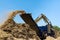 Work conveyor of an industrial wood shredder producing wood chips from roots in construction site