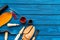 Work desk of shoemaker with instruments, wooden shoe and leather. Blue wooden background top view copy space