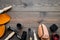 Work desk of shoemaker with instruments, wooden shoe and leather. Dark wooden background top view copy space