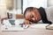 When work doesnt feel like the dream it used to be. a young businesswoman sleeping at her desk in a modern office.