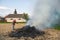 Work in the garden. Farmer burning dried branches