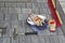 Work gloves, hammer and broom with concrete floor bricks