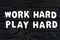 Work Hard Play Hard words on dark wooden background