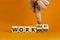Work hard or smart symbol. Businessman turns wooden cubes and changes words `work hard` to `work smart`. Beautiful orange