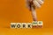 Work hard or smart symbol. Businessman turns wooden cubes and changes words `work hard` to `work smart`. Beautiful orange