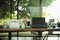 Work from home concept. Closeup laptop on the wooden table surrounded by the office stationaries with blurred background