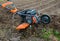 Work on a home farm in the spring. Plowing the field with a cultivator before planting seeds and seedlings.