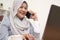 Work from home, remote job, technology and people concept. Happy smiling Asian muslim woman typing on laptop computer  calling on