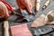 Work in leather shop on dark wooden background close up