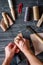 Work in leather shop on dark wooden background top view