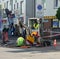 Work mini excavator in cramped street conditions